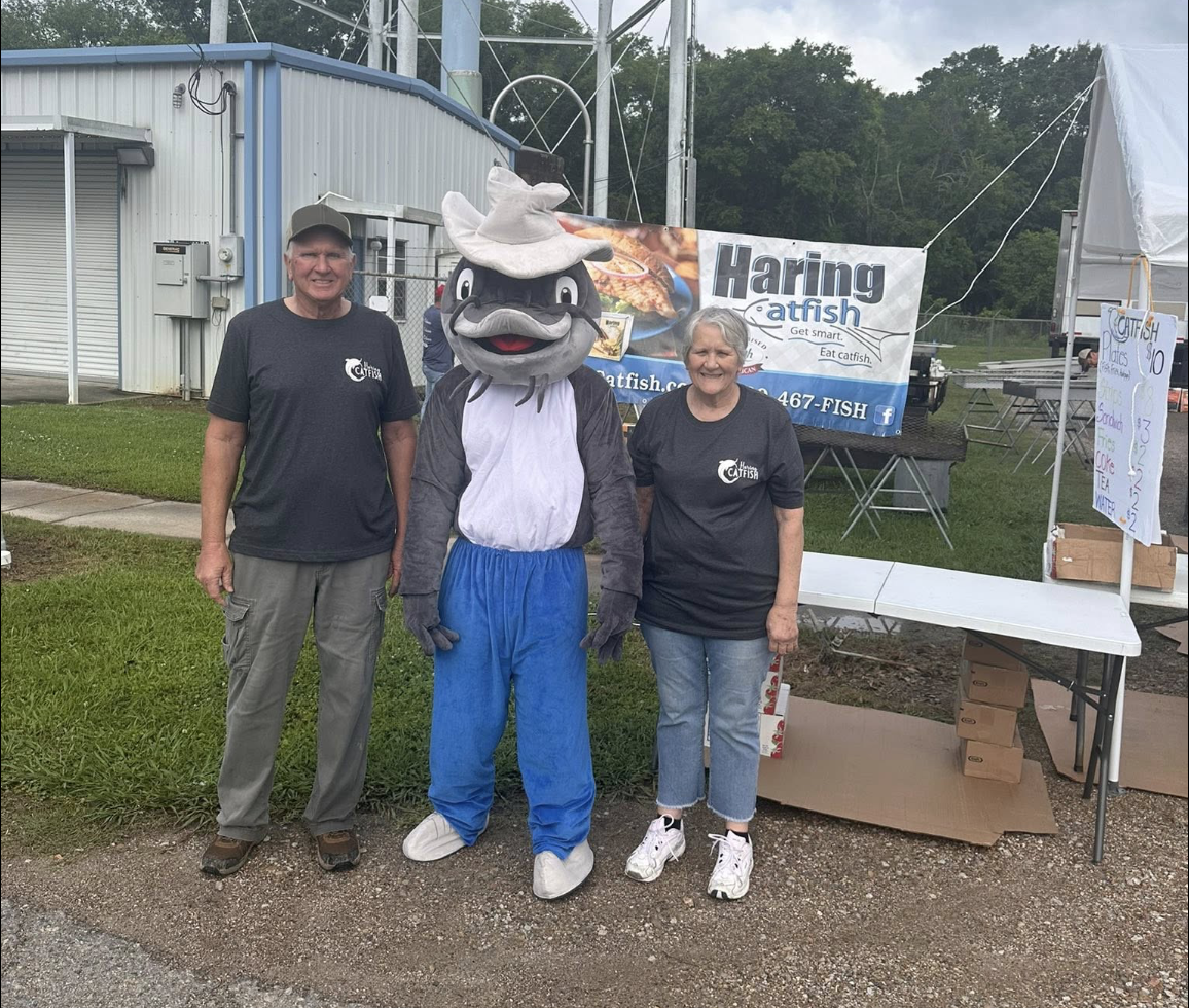 The Haring family with the catfish mascot at their booth